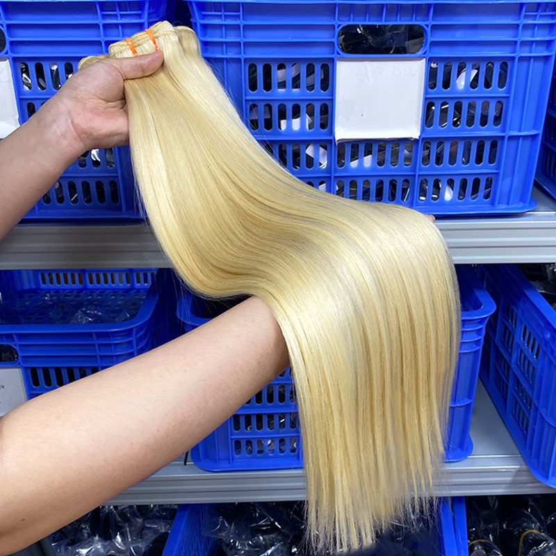 Scarlett Hair Bundles of blonde human hair extensions in a warehouse