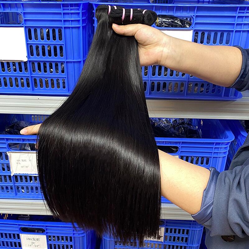 Scarlett Hair Close-up of a person holding a bundle of long, straight, black human hair extensions.